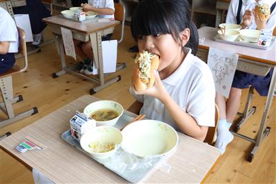 「ちくワンドッグ」をおいしそうに食べる児童　　